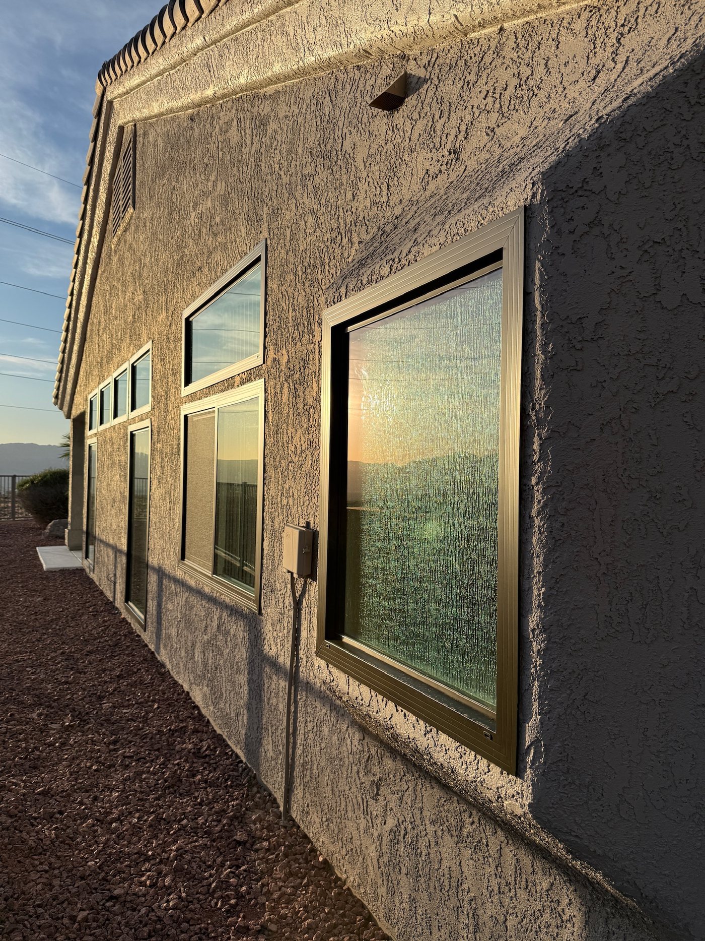 Sunlight reflecting across installed windows on a desert home